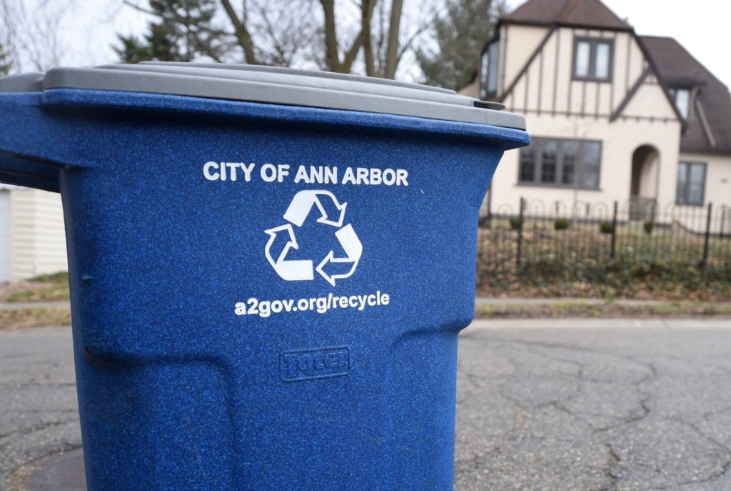 Blue City of Ann Arbor cart outside of a residence.